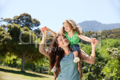 Woman giving daughter a piggyback