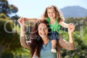 Woman giving daughter a piggyback