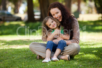 Mother with her daughter sitting in the garden