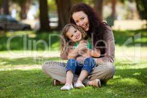 Mother with her daughter sitting in the garden