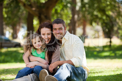 Radiant family sitting in the garden