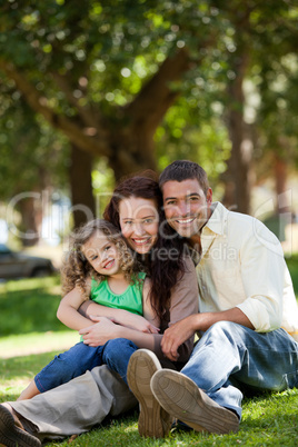 Radiant family sitting in the garden