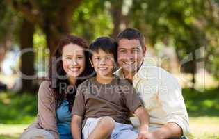 Joyful family sitting in the garden