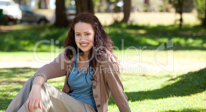 Beautiful woman sitting in the garden