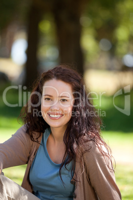 Beautiful woman sitting in the garden