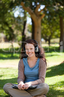 Woman listening to some music in the garden