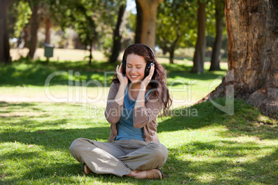 Woman listening to some music in the garden