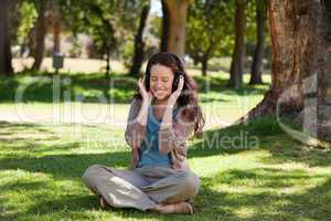 Woman listening to some music in the garden