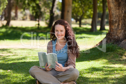 Woman reading a book in the garden