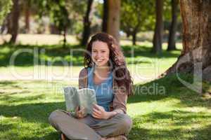Woman reading a book in the garden
