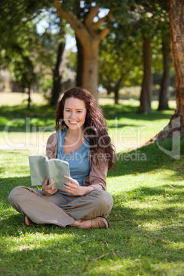 Woman reading a book in the garden