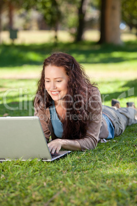 Woman working on her laptop in the park