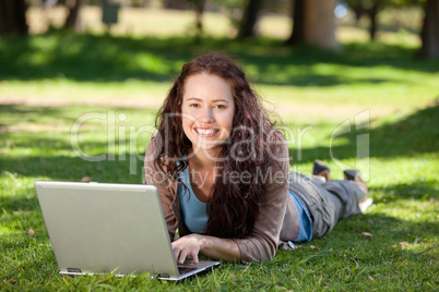 Woman working on her laptop in the park