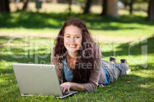 Woman working on her laptop in the park