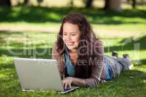 Woman working on her laptop in the park