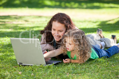 Mother and her daughter working on the laptop