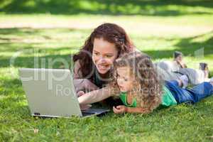 Mother and her daughter working on the laptop