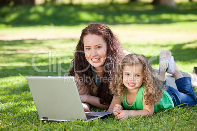 Mother and her daughter working on the laptop