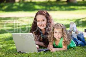 Mother and her daughter working on the laptop