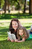 Woman with her daughter reading a book