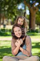 Woman hugging her daughter in the park