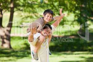 Handsome man giving son a piggyback