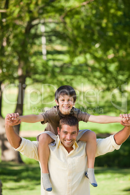 Handsome man giving son a piggyback