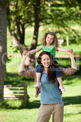 Mother giving daughter a piggyback