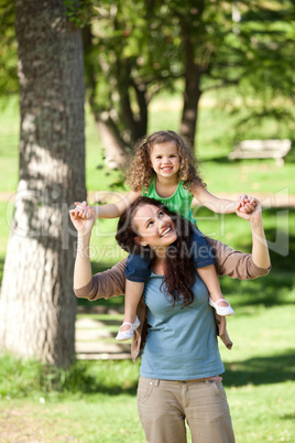 Mother giving daughter a piggyback