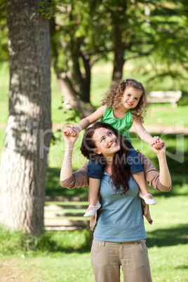 Mother giving daughter a piggyback