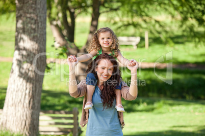 Mother giving daughter a piggyback