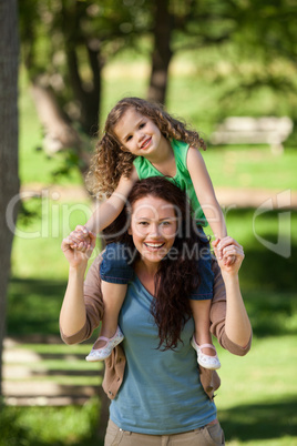 Mother giving daughter a piggyback