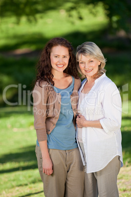 Mother with her daughter looking at the camera in the park