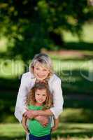 Grandmother and her granddaughter looking at the camera