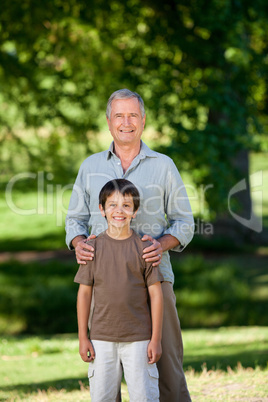 Grandather and his grandson looking at the camera in the park