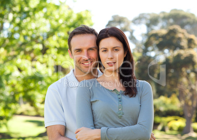 Beautiful couple hugging in the park