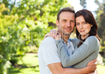 Radiant couple hugging in the park