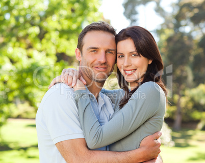 Radiant couple hugging in the park