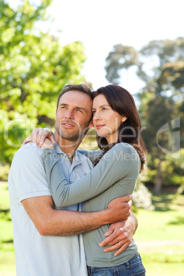 Radiant couple hugging in the park