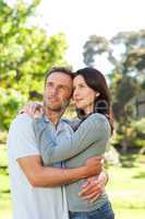 Radiant couple hugging in the park