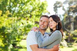 Radiant couple hugging in the park