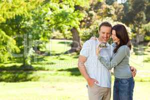 Radiant couple hugging in the park