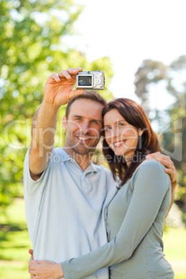 Couple taking a photo of themselves in the park