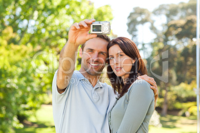 Couple taking a photo of themselves in the park