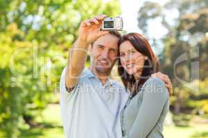 Couple taking a photo of themselves in the park