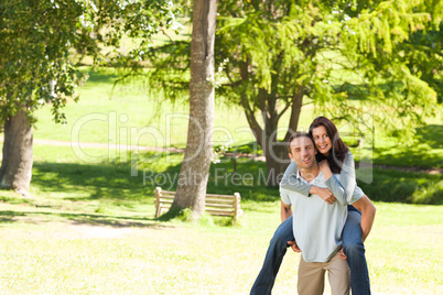 Man giving wife a piggyback