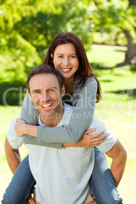 Man giving wife a piggyback