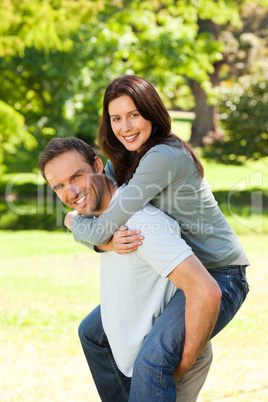 Man giving wife a piggyback