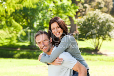 Man giving wife a piggyback