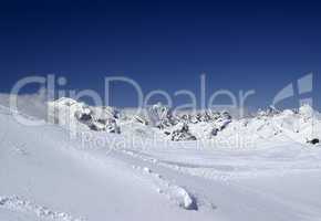 Ski slope against mountain peaks